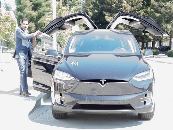 Telangana Industry and Commerce Minister KT Rama Rao with Tesla Model X. (photo/twitter/KT Rama Rao)