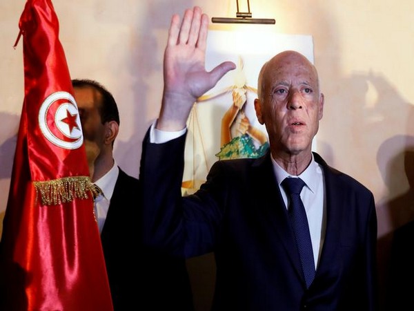 Tunisian presidential candidate Kais Saied reacts after exit poll results were announced on Sunday (Reuters)