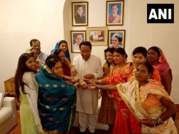 Women tying Rakhi to Madhya Pradesh Chief Minister Kamal Nath. Photo/ANI