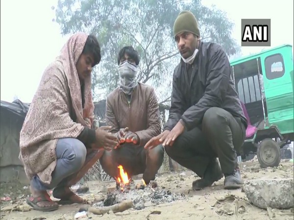 People in Varanasi lit up fire to keep themselves warm (Photo ANI)