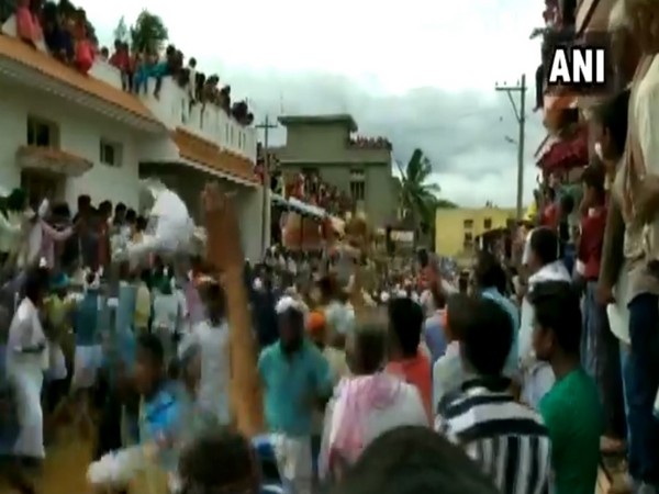 People celebrating 'Kara Hunnime' in Karjagi village, Karnataka on Thursday.
