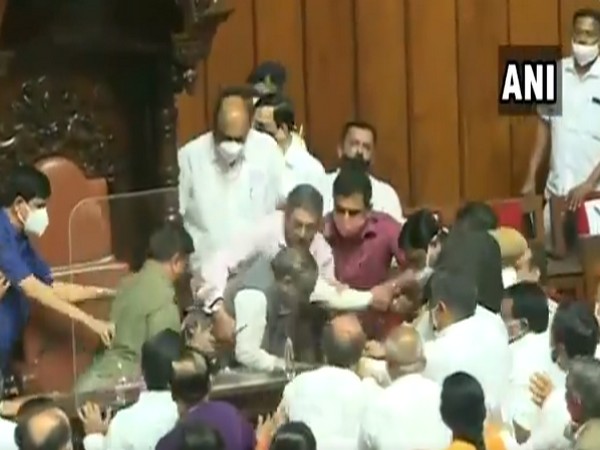 Congress MLCs in Karnataka Assembly forcefully remove the chairman of the legislative council on Tuesday. (Photo/ANI)