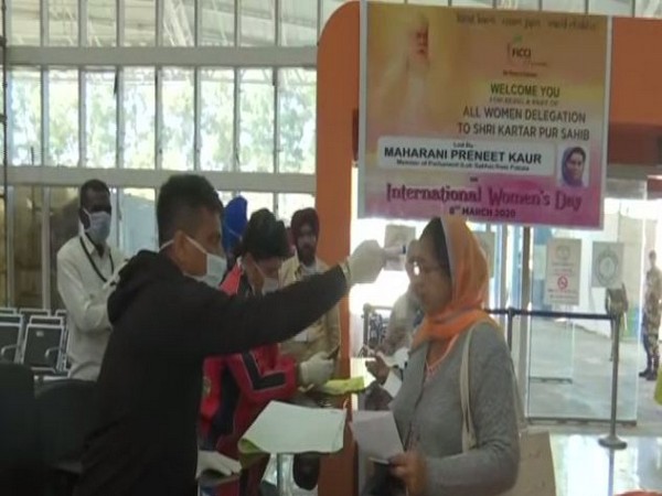 Devotees being checked for their temperature in the wake of coronavirus. Photo/ANI