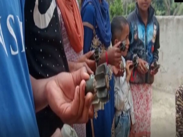 Residents of Manyari village display mortar shells fired by Pakistan. 