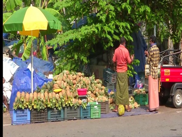 Fruit sellers selling pineapples on roadside in Kerala on Sunday. Photo/ANI