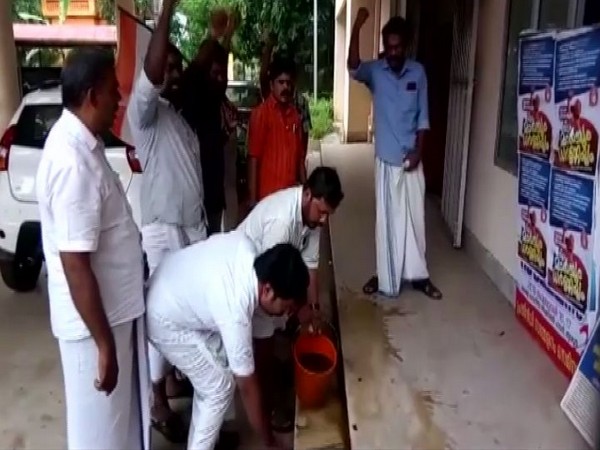 Youth Congress workers allegedly purify the PWD office in Thrissur where Dalit MLA Geetha Gopi had protested on Saturday. (Photo/ANI)