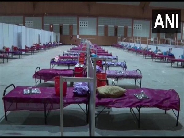 Relatives of the pregnant woman carrying her in a makeshift cloth stretcher