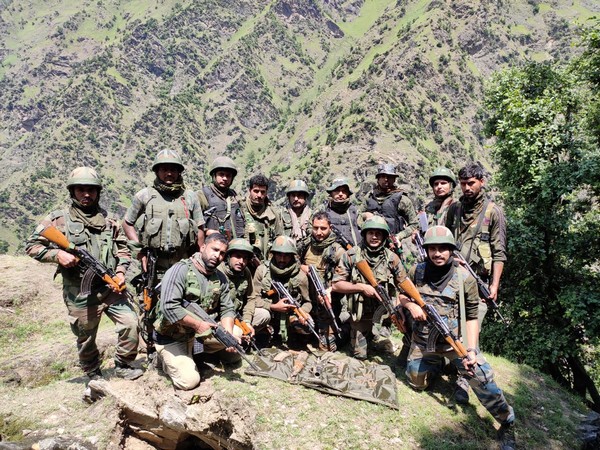 Security force personnel with the recovered arms and ammunition from the operation in Kishtwar