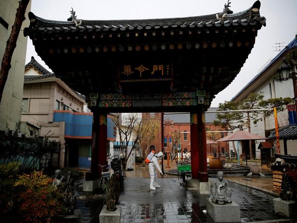 A South Korean solider sprays disinfectant at the herbal medicine market street amid the rise in confirmed cases of coronavirus disease in Daegu, South Korea