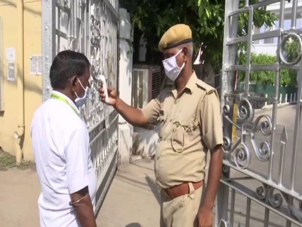 Employees undergoing thermal screening at UP Secretariat. (Photo/ANI)