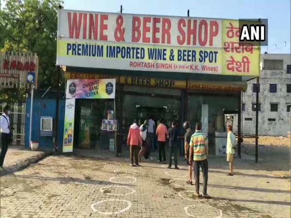 People outside a liquor store at Sohna Adda Chowk in Gurugram, Haryana. Photo/ANI