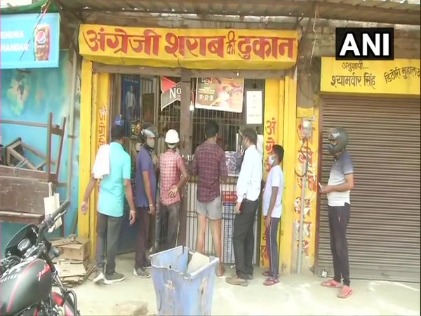 People queue up outside liquor shops in Varanasi. (Photo/ANI)