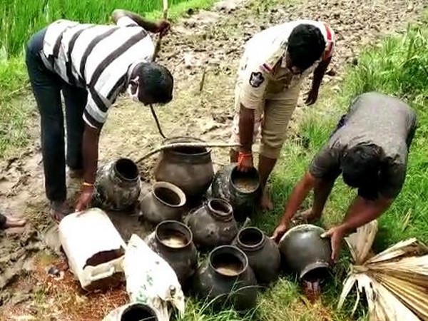 Police destorying liquor and jaggery wash in Andhra Pradesh's Krishna district. (Photo/ANI)