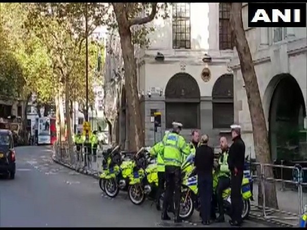 Police stand outside Indian High Commission building in London on Sunday.