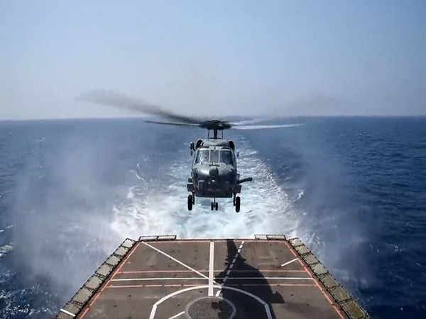 The MH 60R Helo of HMAS Arunta, Royal Australian Navy (RAN) undertakes cross deck operations with INS Shivalik