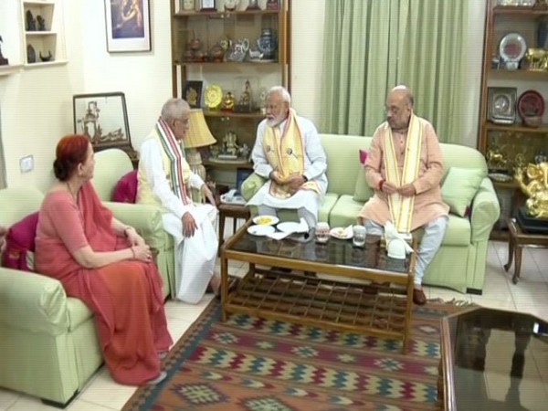 Prime Minister Narendra Modi and Amit Shah meeting Prof MM Joshi at his residence on Friday in New Delhi. Photo/ANI
