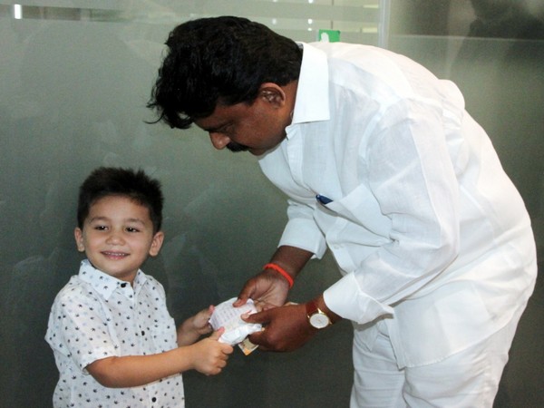 Hemanth handing over his savings to fight the coronavirus. Photo/ANI