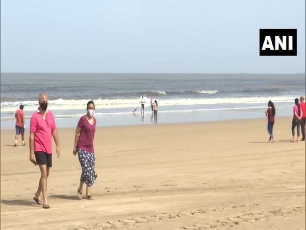 Locals stroll and jog at Mumbai's Juhu beach following relaxations. (Photo/ANI)