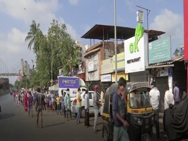 Labourers in a queue to get fitness certificates in Mumbai on Monday. Photo/ ANI
