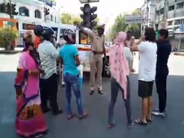 Nagpur police making curfew violators do squats in Nagpur on Tuesday.