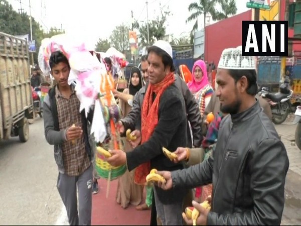 Some Muslims offering fruit to a Kanwar yatri in Aligarh on Sunday.