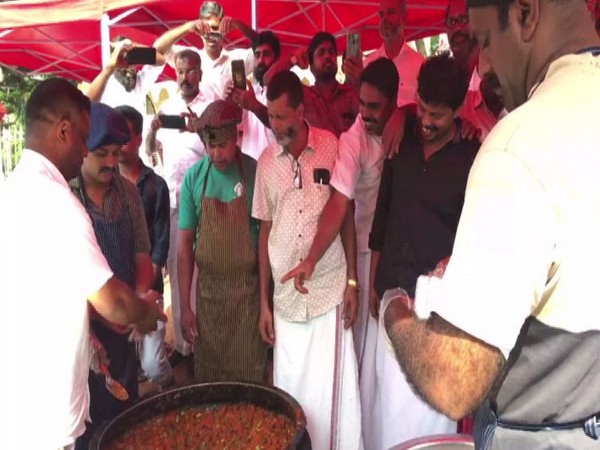 Members of Malappuram District Committee serving biryani to people in Kerala on Friday, which was prepared without onion. Photo/ANI