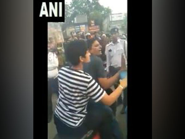 A woman and a man misbehaved&manhandled a traffic police cop on being stopped for not wearing helmet.