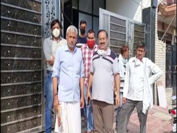 Tulsi Ram, Father of Captain Akhilesh Kumar along with his relatives outside their residence in Mathura on Saturday. (Photo/ANI)