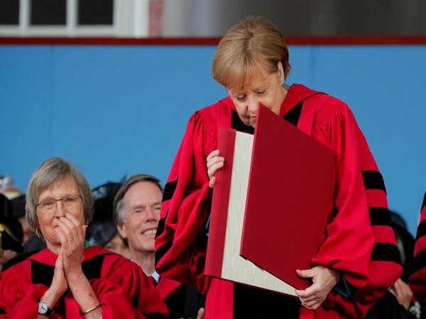 German Chancellor Angela Merkel looks at her honorary Doctor of Laws degree during the 368th Commencement Exercises at Harvard University on Thursday