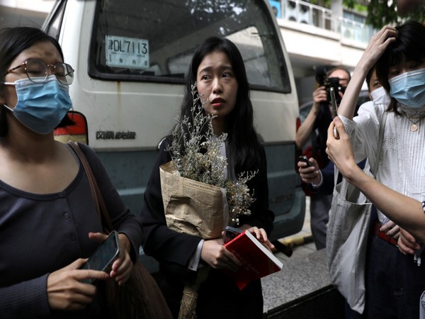 Zhou Xiaoxuan, also known by her online name Xianzi, speaks to supporters as she arrives at a court for a sexual harassment case involving a Chinese state TV host