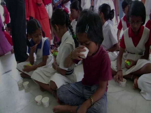 Children were fed milk as part of awareness campaign ahead of Nag Panchami by Basava Kendra in Shivamogga on Saturday. Photo/ANI