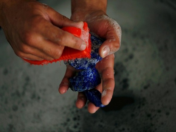 A man washing lapis lazuli. (Photo Credit - Reuters)