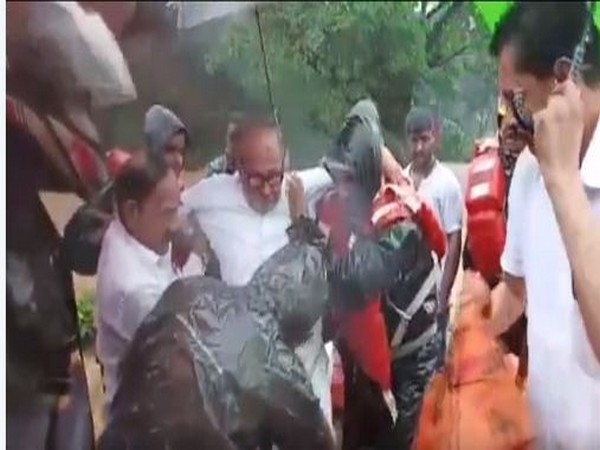 Former Union Minister B Janardhana Poojary being rescued by the district administration officials from his house in flood-affect Bantwal on Saturday. Photo/ANI