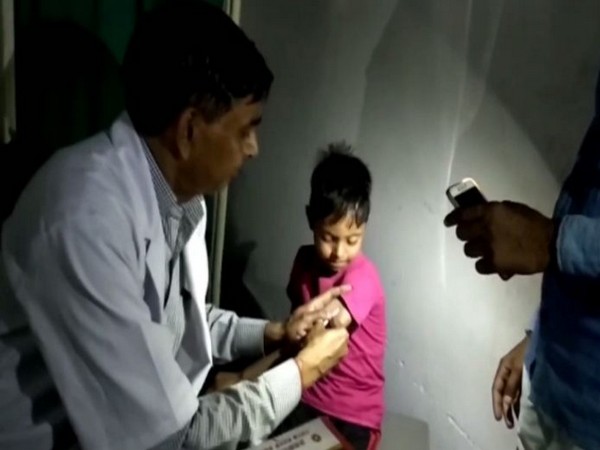 Visual of a doctor treating a child in flashlight at UP hospital. Photo/ANI