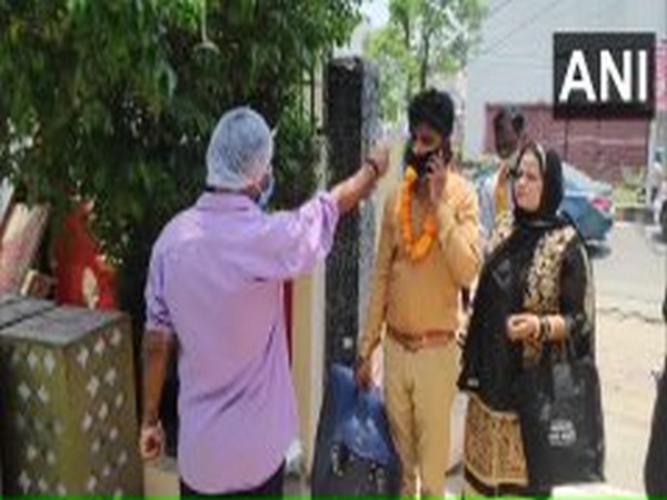    Thermal screening of guests is being done at marriage function in Moradabad on Saturday. Photo/ANI