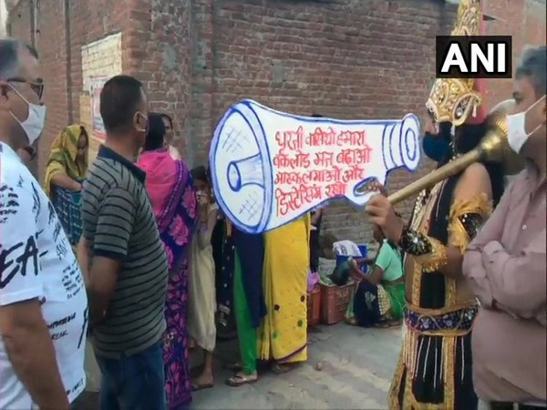 A local artist, dressed as Yamraj, creating awareness among people about COVID-19. (Photo/ANI)