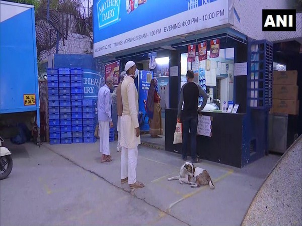 Social distancing being practised by buyers at a Mother Dairy store in Delhi's Patparganj on Friday. Photo/ANI