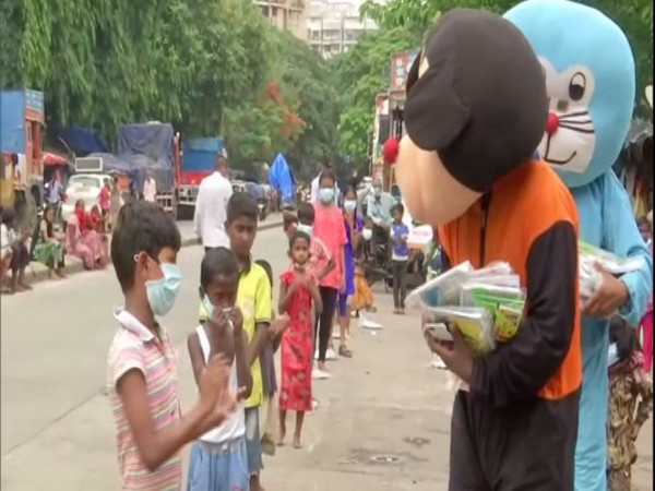 Members of Sion friends circle distribute study material to children staying in slum area of Mumbai on Sunday. Photo/ANI