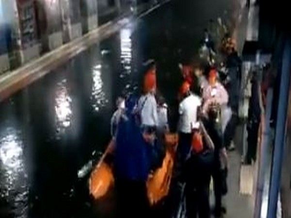 Passengers being rescued after two local trains stuck between Masjid and Bhaykhala railway station in Mumbai on Wednesday. Photo/NDRF/Twitter