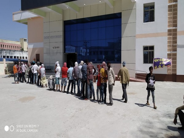 People standing in queue outside a hospital in Muzzafarpur [Photo/ANI]