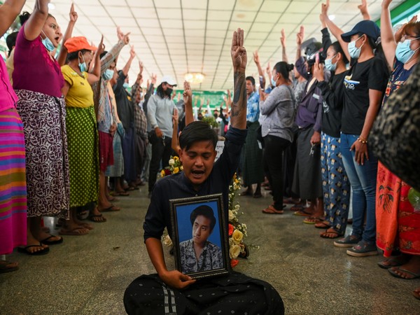 Myanmar citizens flashing a three-finger salute as they hold funeral of one of the victims of military security forces. (Photo credit: Reuters)
