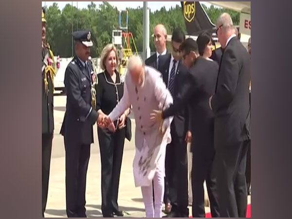 Prime Minister Narendra Modi left netizens impressed when he picked up a flower from the ground. Photo/ANI