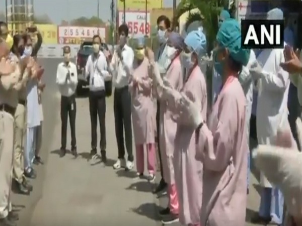 Police officers and doctors applaud each other for their services amid COVID-19 lockdown in Bhopal. Photo/ ANI