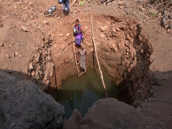 Village women drawing polluted water in Navsari on Sunday. Photo/ANI
