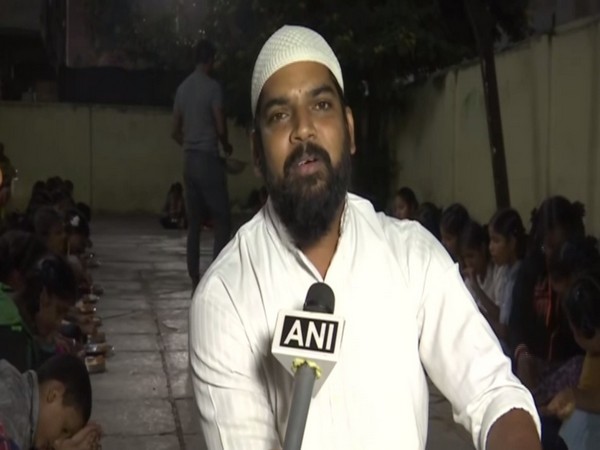 Khwaja Moinuddin feeding children at an orphanage in Hyderabad. Photo/ANI