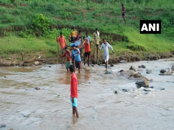 Local youth carrying the body of the man killed by Naxals in Andhra Pradesh. Photo/ANI