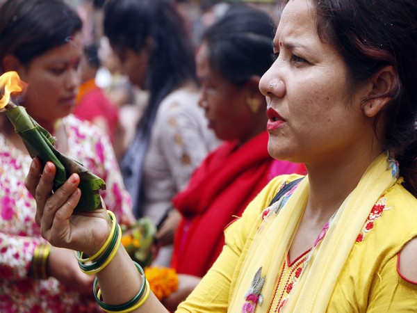 A woman offers prayers on the last day of Shravan in Nepal