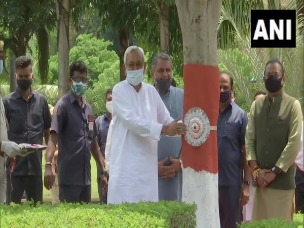 Bihar CM Nitish Kumar ties rakhis to trees. (Photo/ ANI)