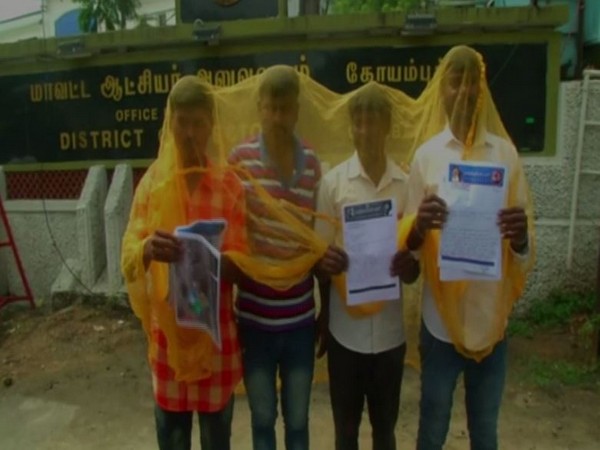 Protesters wearing mosquito net outside the District Collector's office in Coimbatore on Tuesday.