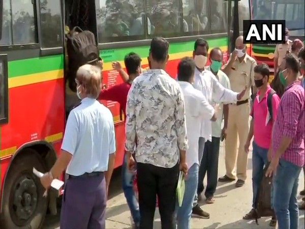 Migrant labourers of Odisha boarding bus to reach Lokmanya Tilak Terminus on Tuesday. (Photo/ANI)